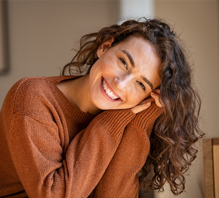 A woman smiling showing cosmetic dentistry results
